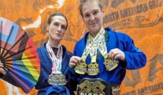 Cordelia Gregory, left, and Corissa Griffith, men identifying as women, post with their medals at the Georgia Grappling & BJJ Championship in October in Marietta, Georgia.