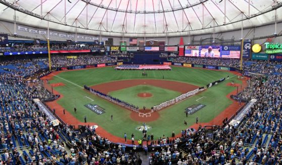 The Tampa Bay Rays and the Texas Rangers line up for the national anthem prior to the start of Game One of the Wild Card Series at Tropicana Field on Tuesday in St Petersburg, Florida.