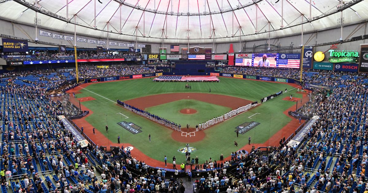 The Tampa Bay Rays and the Texas Rangers line up for the national anthem prior to the start of Game One of the Wild Card Series at Tropicana Field on Tuesday in St Petersburg, Florida.
