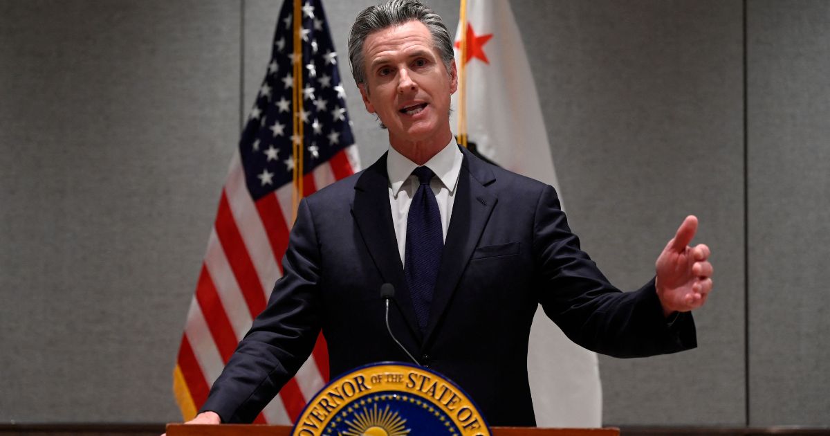 Governor of California Gavin Newsom answers a question during a press conference in Beijing on Wednesday.