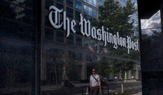 A man walks past The Washington Post on Aug. 5, 2013, in Washington, D.C.