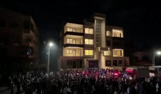 Protesters attempt to storm the Israeli embassy after the Gaza hospital explosion.