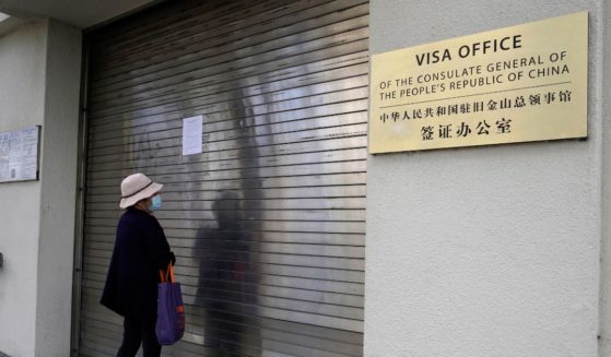 A woman reads a sign that the visa office is temporarily closed at the Chinese consulate in San Francisco on Tuesday.