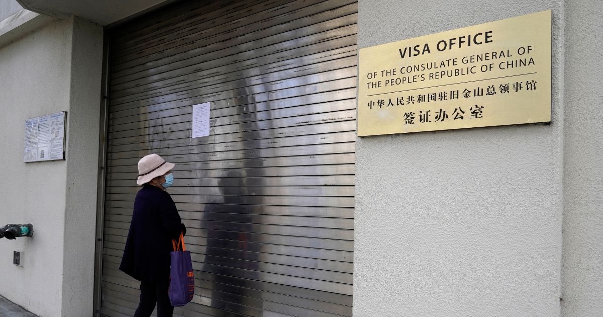 A woman reads a sign that the visa office is temporarily closed at the Chinese consulate in San Francisco on Tuesday.