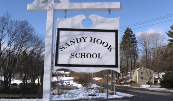 A sign stands near the site of the December 2012 Sandy Hook school shooting on the day of the National School Walkout on March 14, 2018, in Sandy Hook, Connecticut.