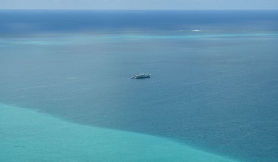 This photo taken on September 28, 2023 shows an aerial view of Chinese coast guard ships anchored inside the lagoon of the Chinese-controlled Scarborough Shoal during a maritime surveillance flight by the Philippine Bureau of Fisheries and Aquatic Resources (BFAR) over disputed waters of the South China Sea.