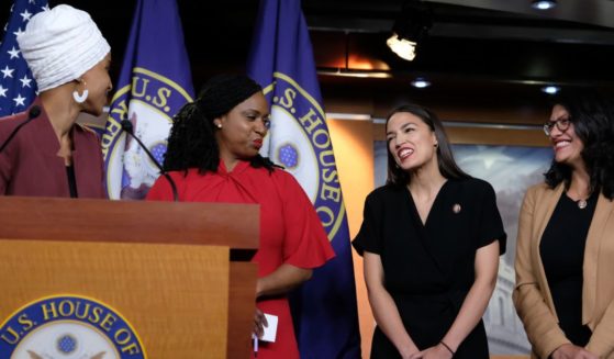 Rep. Ilhan Omar (D-MN) pauses while speaking as Reps. Ayanna Pressley (D-MA), Alexandria Ocasio-Cortez (D-NY), and Rashida Tlaib (D-MI) react during a press conference at the U.S. Capitol on July 15, 2019 in Washington, D.C.