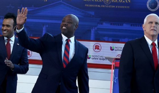 South Carolina Sen. Tim Scott waves to the audience as he enters the stage for the Sept. 27 Republican primary debate in Simi Valley, California, with former Vice President Mike Pence, right, and businessman Vivek Ramaswamy, left.