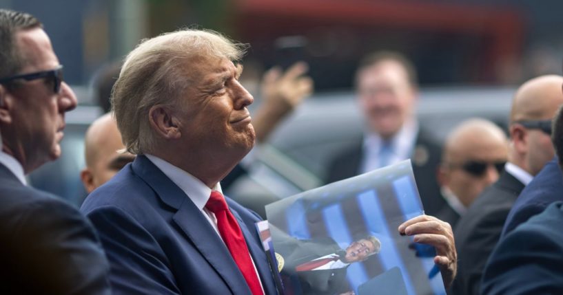 Former U.S. President Donald Trump signs autographs outside a Carvel Ice Cream and Cake Shop during the California GOP convention on September 29, 2023 in Los Angeles, California.