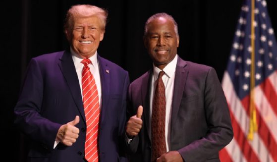 Former President Donald Trump, left, and former Housing and Urban Development Secretary Ben Carson, right, give a thumbs up for the cameras during a rally Sunday in Sioux City, Iowa. Carson has endorsed Trump as the GOP presidential nominee in 2024.