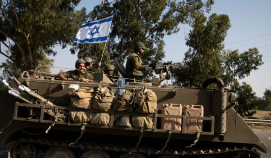 Israeli soldiers in an armoured personnel carrier head towards the southern border with the Gaza Strip on Sunday in Sderot, Israel.