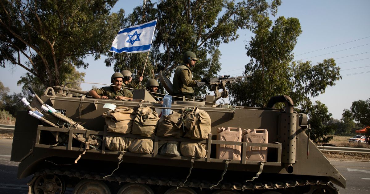 Israeli soldiers in an armoured personnel carrier head towards the southern border with the Gaza Strip on Sunday in Sderot, Israel.
