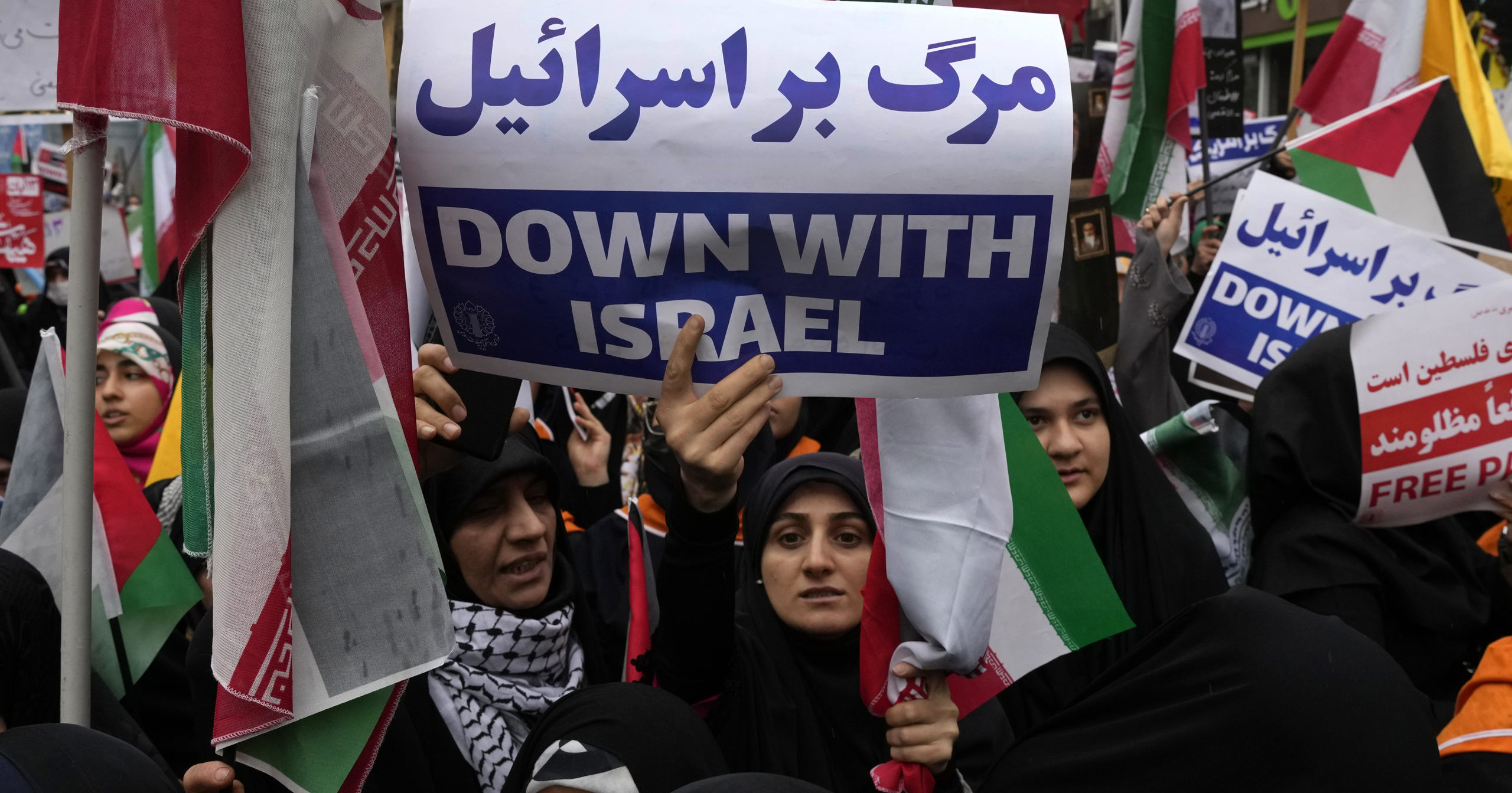 An Iranian demonstrator holds an anti-Israeli placard during a Saturday rally in front of the former U.S. Embassy in Tehran, Iran.