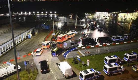 Police vehicles and ambulances arrive at the scene of a security breach at the Hamburg Airport Saturday in Hamburg, Germany.