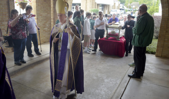 Bishop Joseph Strickland walks in front of a reliquary bearing the bones of Saint Maria Goretti, dubbed “The Little Saint of Great Mercy,” into the sanctuary at Cathedral of the Immaculate Conception in Tyler, Texas, on Nov. 2, 2015.