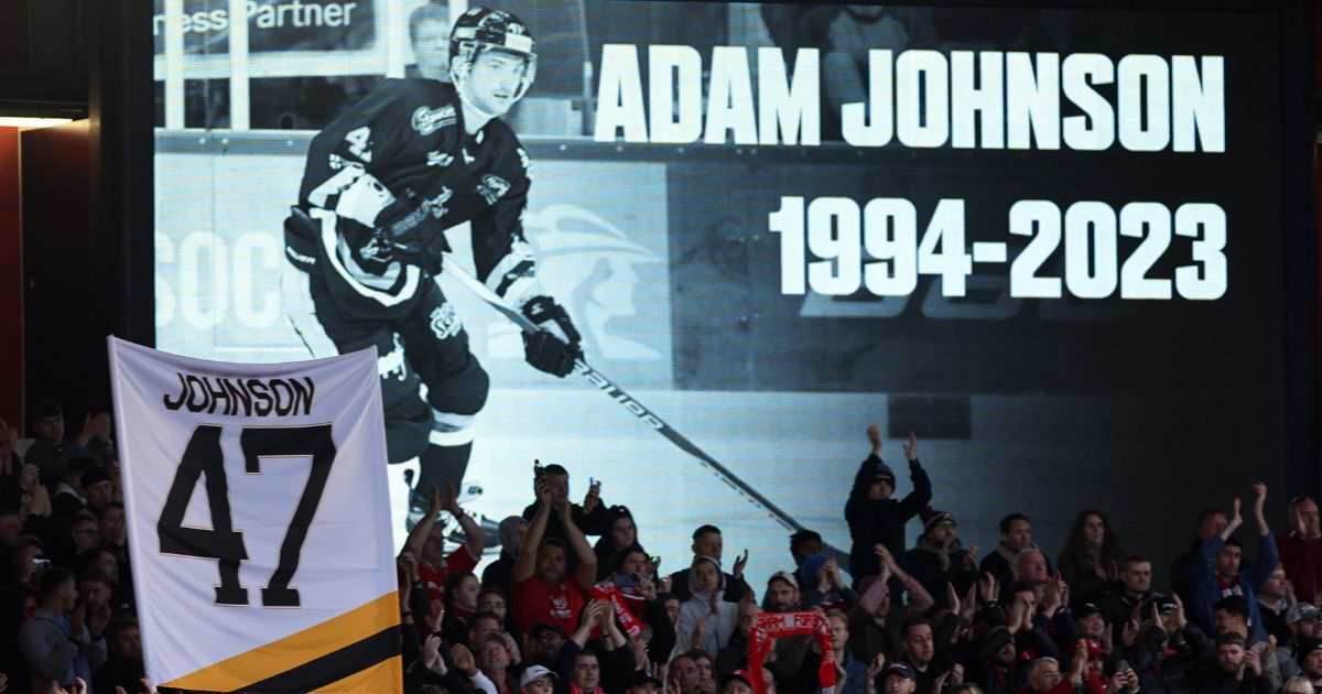 Fans hold a minute applause for ice hockey star Adam Johnson on the 47th minute during the Premier League match between Nottingham Forest and Aston Villa in Nottingham, England, on Nov. 5, following Johnson's death on Oct. 28.