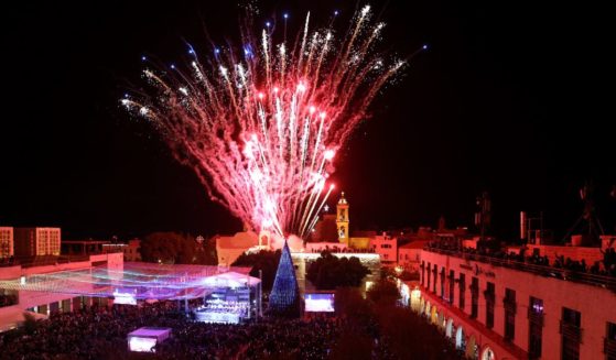 Fireworks light the sky to mark the lighting of a Christmas tree at the Manger Square near the Church of the Nativity, revered as the site of Jesus Christ's birth, as the Palestinian city of Bethlehem prepares for Christmas season on Dec. 4, 2021.