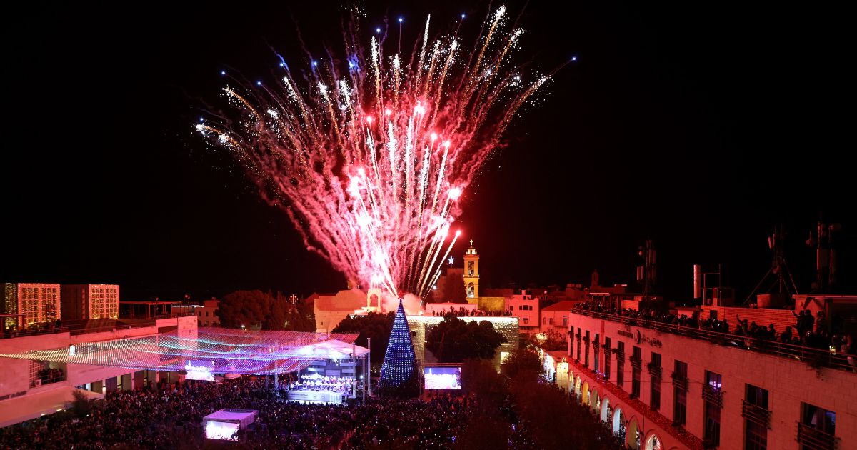 Fireworks light the sky to mark the lighting of a Christmas tree at the Manger Square near the Church of the Nativity, revered as the site of Jesus Christ's birth, as the Palestinian city of Bethlehem prepares for Christmas season on Dec. 4, 2021.
