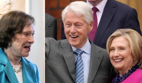 At left, Rosalynn Carter looks on during a visit with the president of the Dominican Republic in Santo Domingo on Oct. 8, 2009. At right, former President Bill Clinton and former first lady Hillary Clinton wave to reporters during an event in Belfast, Northern Ireland, on April 17.