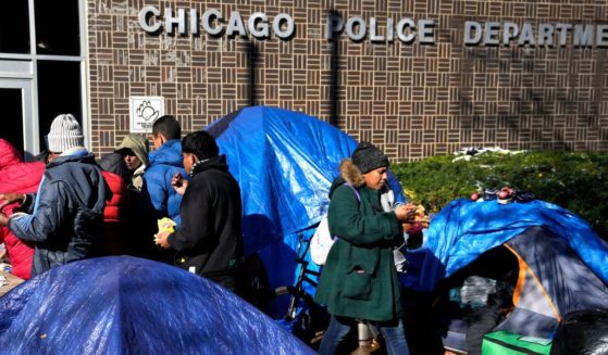 A meal is served to migrants living in a tent community outside a Northside police station in Chicago on Nov. 1.
