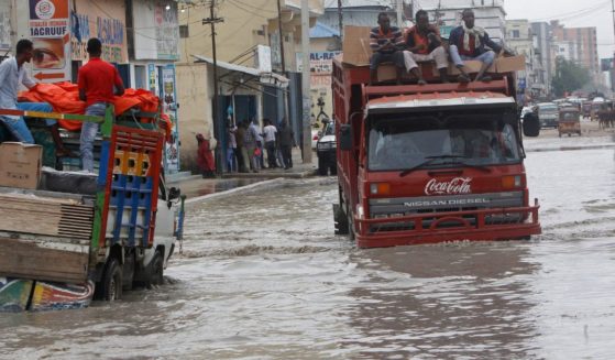 Vehicles try to maneuver through floodwater caused by heavy rain in Mogadishu Saturday. Floods caused by torrential rainfall have killed at least 31 people in various parts of Somalia, authorities said Sunday.