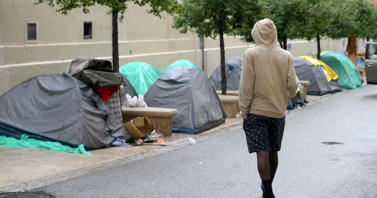 An unaccompanied juvenile migrant stands at a camp in downtown Marseille, southern France, on Sept. 21. France has declared that it will deport certain immigrants that pose a threat without waiting for the European Court of Human Rights.