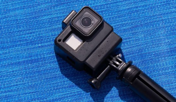 An action camera, like a GoPro, is pictured on a blue background. A family in Massachusetts made a gruesome discovery after they put a GoPro down a well and discovered the body of their missing family member.