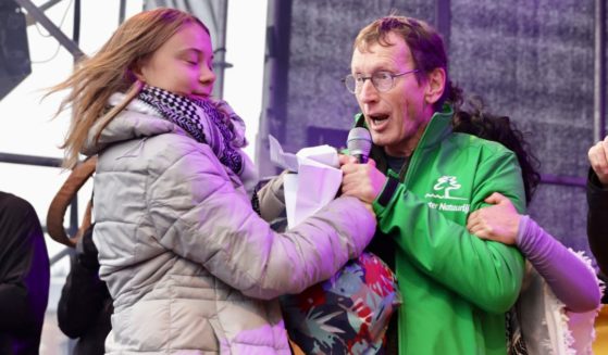 Greta Thunberg is briefly interrupted by a man who approached her on stage and grabbed her microphone during a climate march in Amsterdam on Sunday.