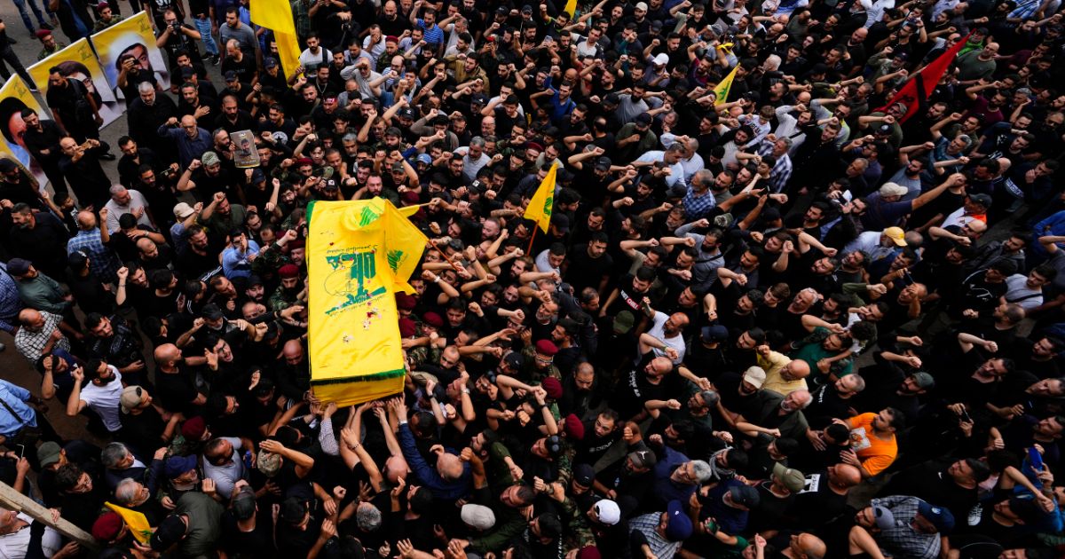 Hezbollah fighters carry the coffin of their comrade, Mohammed Ali Assaf, who was killed by an Israeli strike in Syria Friday, during his funeral procession in the southern Beirut suburb of Dahiyeh, Lebanon, Saturday. Skirmishes between the Iran-backed group and Israeli military continue to intensify along the Lebanon-Israel border, threatening to escalate into another front in the Mideast’s latest war.