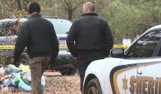 Investigators at the homeless encampment near Autryville, North Carolina, where four people were found shot to death Sunday.