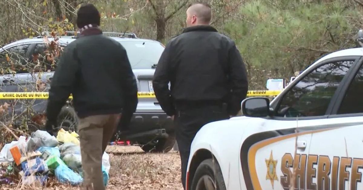 Investigators at the homeless encampment near Autryville, North Carolina, where four people were found shot to death Sunday.
