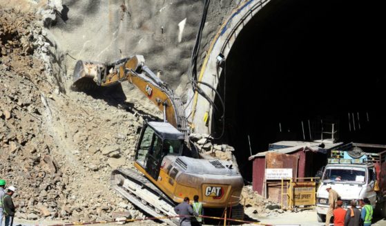Heavy machinery works at the entrance to the site of an under-construction road tunnel that collapsed in mountainous Uttarakhand state, India. Forty workers were trapped in the collapsed road tunnel for an eighth day Sunday as rescuers waited for a new machine to drill through the rubble so they could crawl to their freedom.