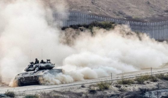 An Israeli tank rolls into battle on Tuesday along the border with the Gaza Strip.
