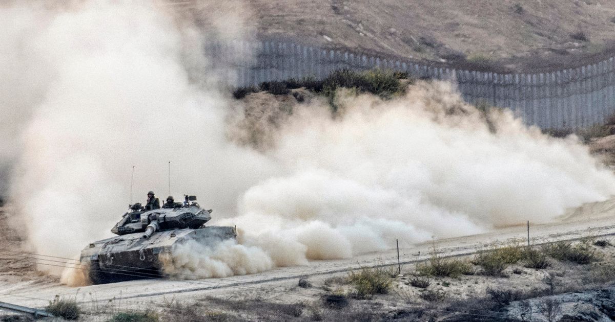 An Israeli tank rolls into battle on Tuesday along the border with the Gaza Strip.
