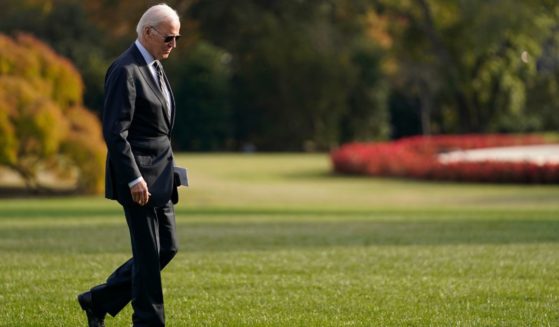 President Joe Biden walking in sunglasses