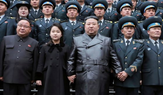 North Korean leader, Kim Jong Un, center, and his daughter, center left, pose with staff of the National Aerospace Technology Administration following the launch of a spy satellite in Pyongyang, North Korea, on Thursday.