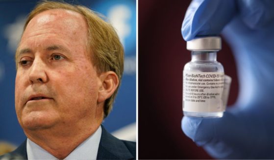 Texas Attorney General Ken Paxton makes a statement at his office on May 26 in Austin, Texas. A nurse holds a container of the Pfizer-BioNTech COVID-19 vaccine on Dec. 17, 2020, in Chicago.