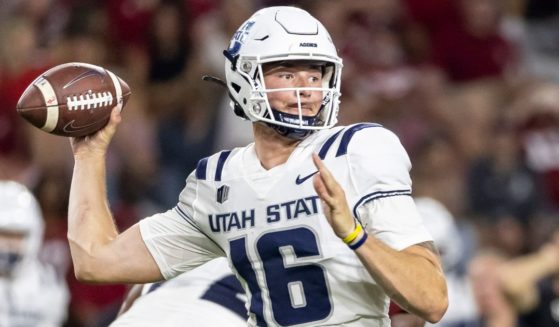Utah State quarterback Levi Williams plays during the second half of an NCAA college football game in Tuscaloosa, Alabama, on Sept. 3, 2022.