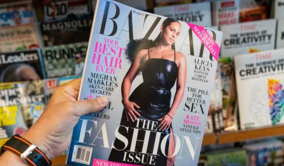 A stock photo from August 2019 shows a person holding a copy of Harper's Bazaar magazine at a news stand in San Francisco.
