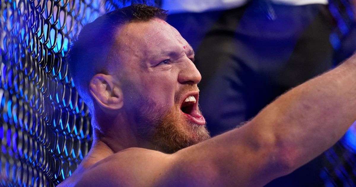 Conor McGregor yells as he sits on the mat after suffering an injury during his lightweight mixed martial arts bout with Dustin Poirier at UFC 264 in Las Vegas on July 10, 2021.