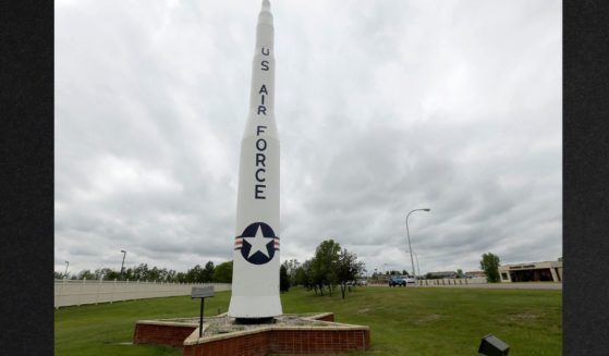 A retired Minuteman 1 missile stands at the main entrance to Minot Air Force Base, North Dakota, in a 2014 file photo. The base is defending itself from claims of political bias after an unofficial message cautioning airmen to not attend a conservative political rally began circulating on social media.