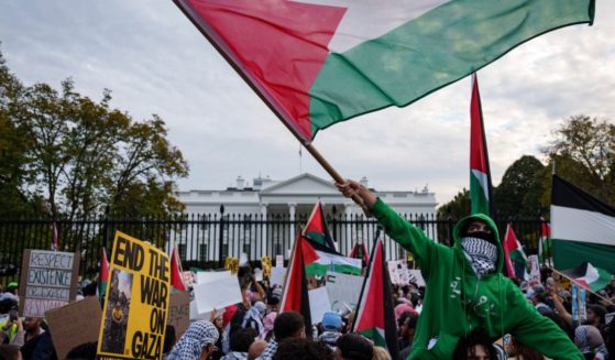 Demonstrators fly Palestinian flags outside the White House on Saturday in Washington, D.C.