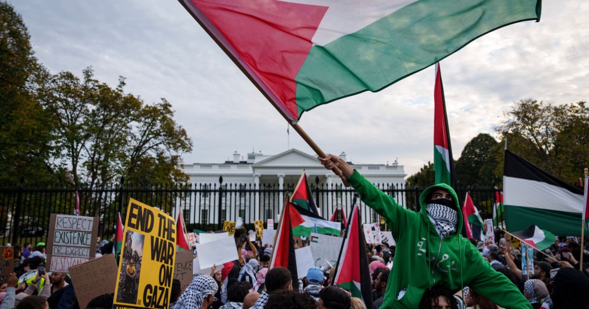 Demonstrators fly Palestinian flags outside the White House on Saturday in Washington, D.C.