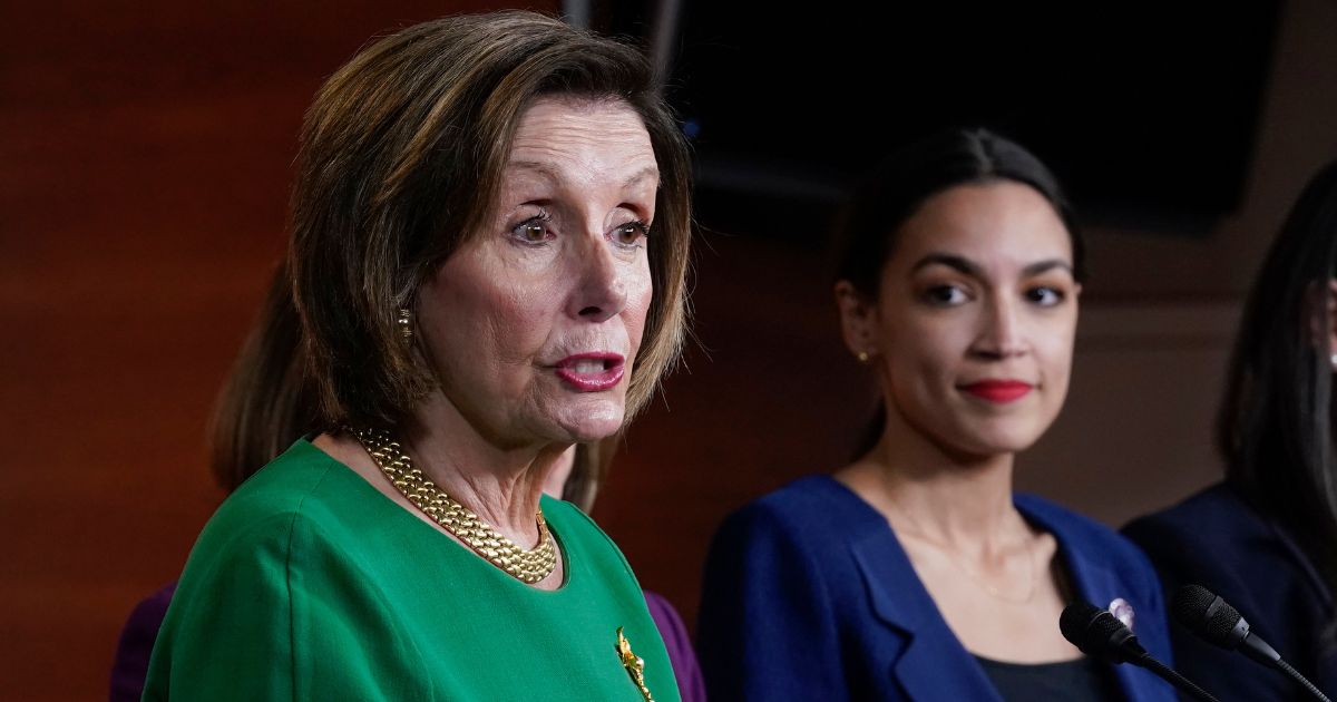 New York Rep. Alexandria Ocasio-Cortez, right, eyes then-House Speaker Nancy Pelosi of California during a June 2021 news conference. A new book confirms that there was no love lost between the two Democrats when Pelosi was in leadership.