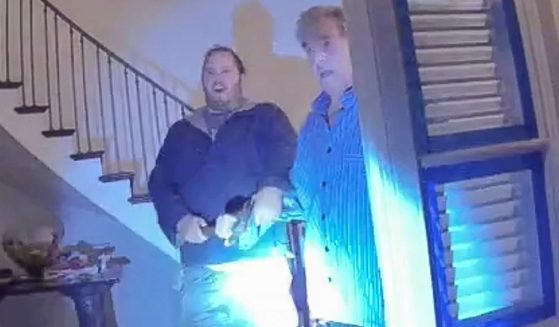 Police footage from Dec. 28, 2022, shows David DePape, left, and Paul Pelosi, right, both holding onto a hammer when greeting officers at the door of the Pelosi home. On Thursday DePape was found guilty on one count of attempted kidnapping and one count of assault.