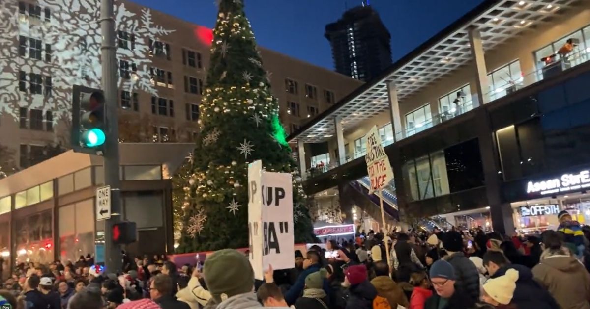Pro-Palestinian protesters interrupt the Christmas tree lighting ceremony in Seattle on Friday.