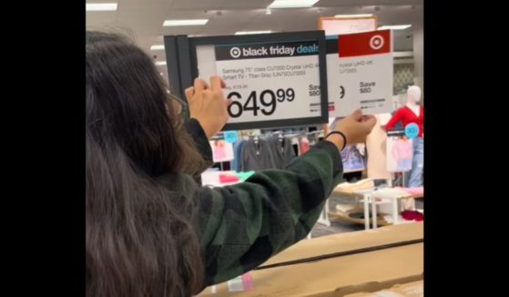 A shopper looks at the prices behind the "Black Friday" labels at Target.