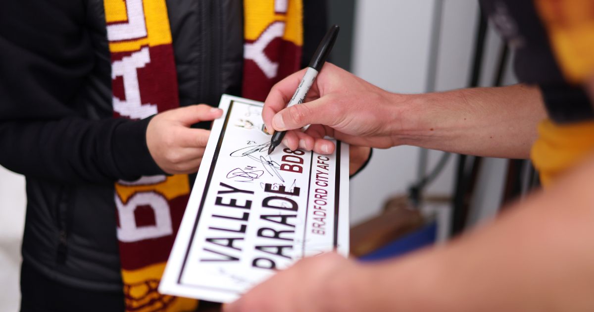 A Valley Parade sign is signed by a player before the Sky Bet League soccer playoff match between Bradford City and Carlisle United on May 14 in Bradford, England. Bradford is celebrating "multiculturism" this holiday season.