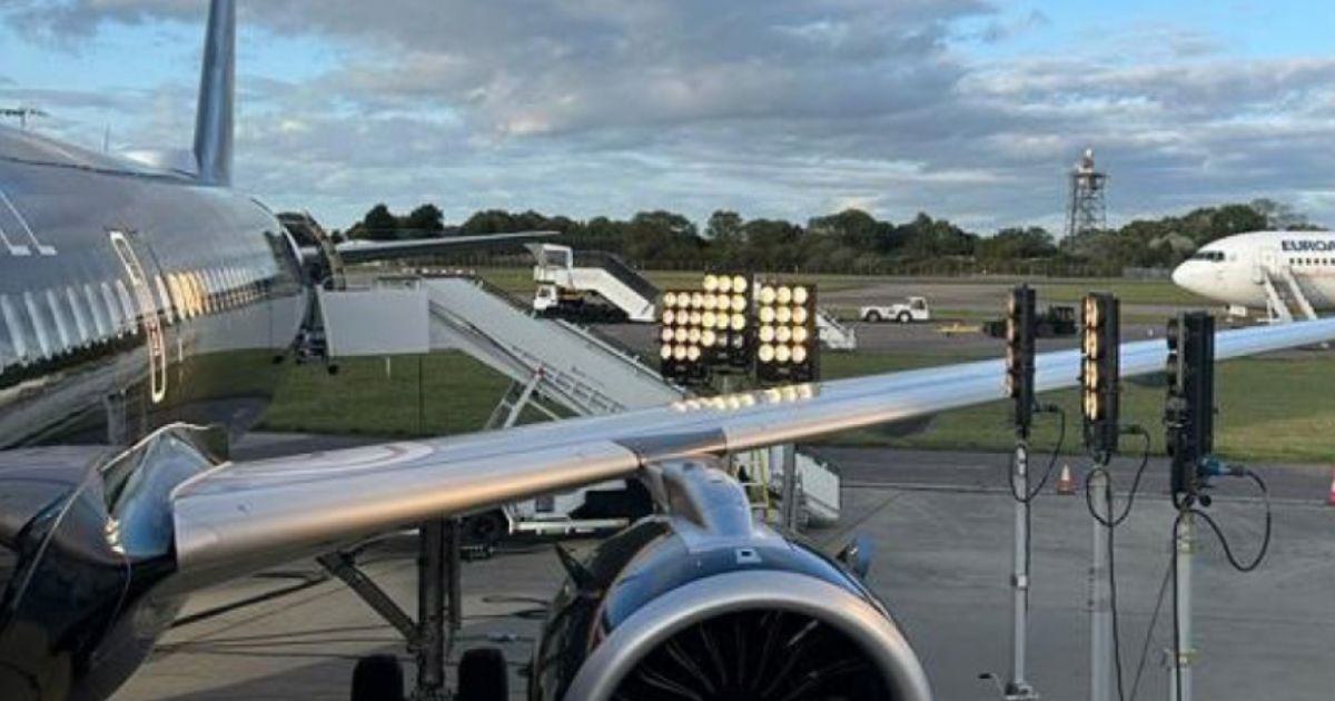 Floodlights illuminate Airbus A321--253NX (G-OATW) prior to an incident on Oct. 4 where the plane was forced to land after takeoff due to missing and dislodged window panes.