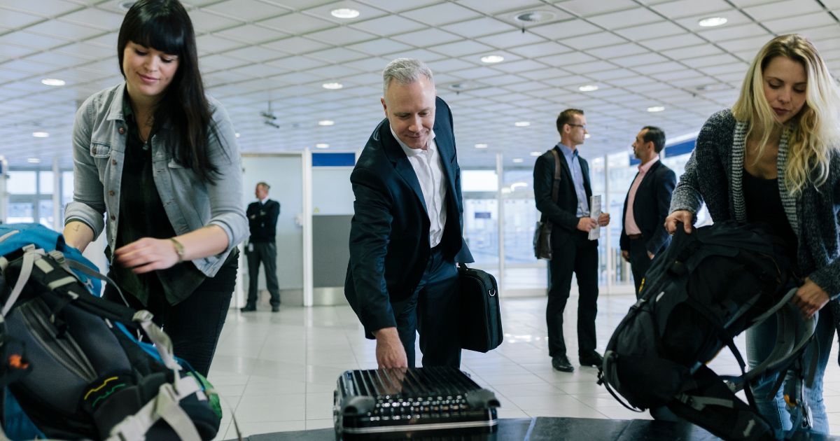 The above stock image is of people at baggage claim.